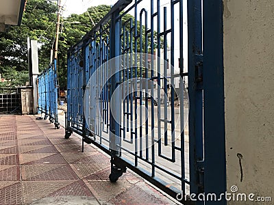 Oil painted Blue color Manual operated sliding door for front gate entrance of an residential complex Stock Photo