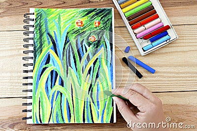 Oil pastels crayons colorful picking art drawing on wood table. Stock Photo