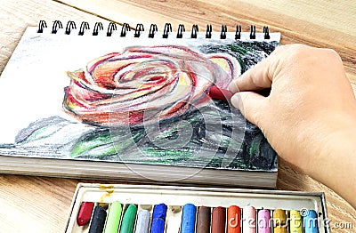 Oil pastels crayons colorful picking art drawing on wood table. Stock Photo