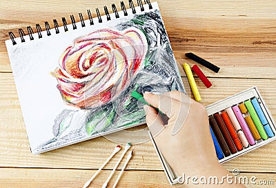 Oil pastels crayons colorful picking art drawing on wood table. Stock Photo