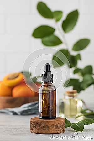 Oil with peach kernel extract in a brown glass pipette. Natural cosmetic. Stock Photo