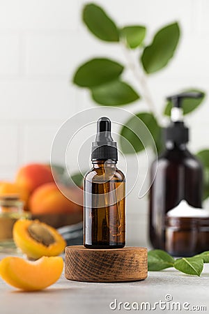 Oil with peach kernel extract in a brown glass pipette. Natural cosmetic. Stock Photo