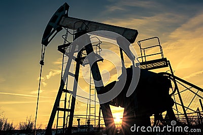 Oil pump jack and wellhead on an oil field. Mining and petroleum industry. Power generation concept. Stock Photo