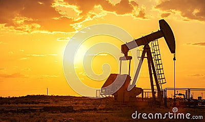 Oil pump oil rig energy industrial machine for petroleum in the sunset background Stock Photo