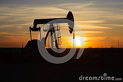 oil pump silhouette with a sunrise backdrop Stock Photo