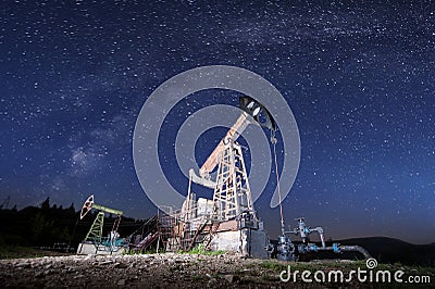 Oil pumps on the oil field in the night Stock Photo