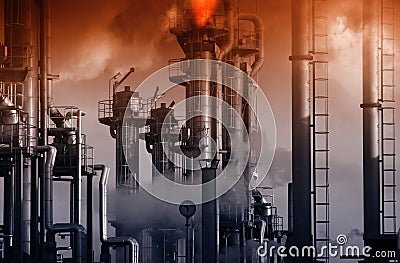 Oil refinery with burning safety flames and red sky Stock Photo