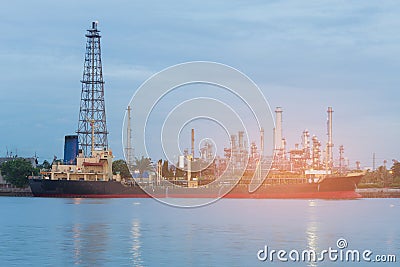 Oil refinery river front and tank boat Stock Photo