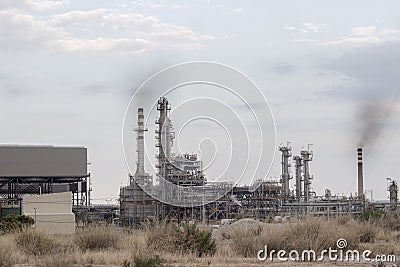 Oil refinery with visible smoke coming out of chimneys; pollution concept, with copy space Stock Photo