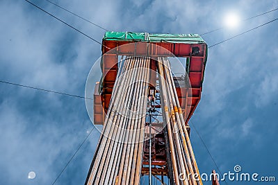 Oil rig derrick in oilfield against the bright blue sky. Drilling rig in oil field for drilled into subsurface in order Stock Photo