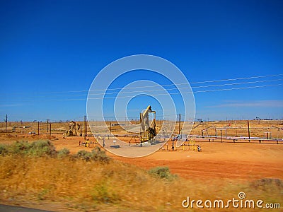 Oil rigs/oil drilling equipment in a field in a california valley Stock Photo