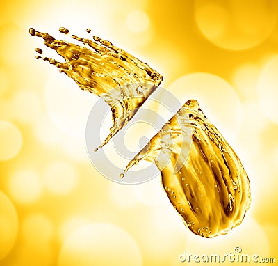 Oil splash on gold bokeh background Stock Photo