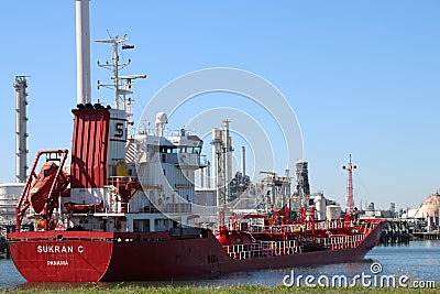 Oil tainker Sukran C in the botlek port at chemical industries in the Botlek Harbor in Rotterdam. Editorial Stock Photo