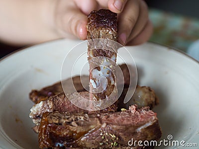 Oil tallow on beef steak stick on woman hand saturated fatty acid Stock Photo