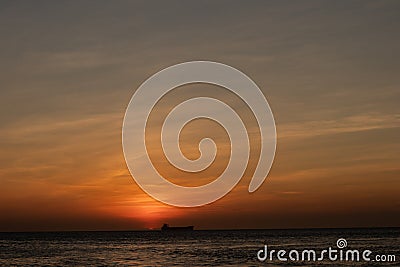Oil tanker ship at sunset in the sea Stock Photo