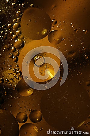 Oil and water circles abstract macro, gold and shiny drops and buubles. Stock Photo