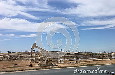 An oil well pumps crude out of the fields, California Stock Photo