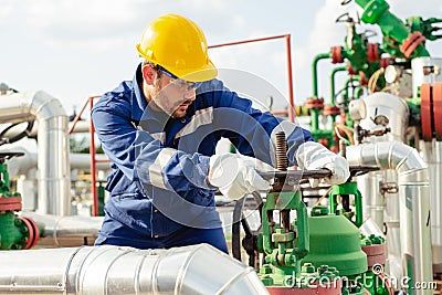 Oil worker is turning valve on the oil pipeline Stock Photo