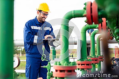Oil worker using portable radio and laptop Stock Photo