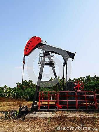 Oilfield Pump jack rocking horse or pumpjack over a wellhead Stock Photo