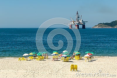 An oilrig looms over a beach near Rio de Janiero Editorial Stock Photo