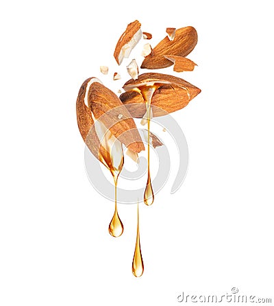 Oily drops dripping from crushed almonds close up isolated on white background Stock Photo