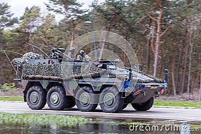 Oirschot Netherlands, April 9 2024: A Dutch army Boxer on the road in a column for exercise Quadriga Steadfast Defender Editorial Stock Photo