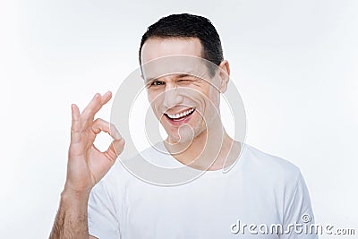 Delighted happy man winking Stock Photo