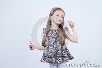 OK sign. Little girl with thumb up. Show the hand sign perfectly. Advertisement. Stock Photo