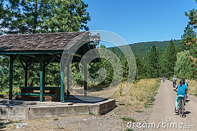 Okanagan Valley, Canada - August 04, 2018: Kettle Valley Railway biking trail through orchards near Penticton Canada. Editorial Stock Photo