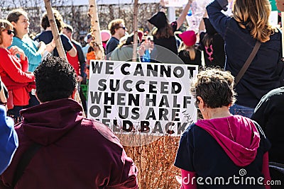 Womens March - protestors around sign that says We cannot succeed when half of us are held back Editorial Stock Photo