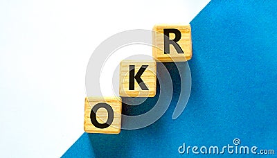 OKR, objectives and key results symbol. Concept words OKR objectives and key results on wooden cubes on a beautiful white Stock Photo