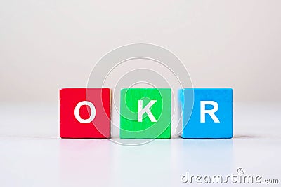 OKR text Objectives, Key and Results wooden cube blocks on table background. business target and focus concepts Stock Photo