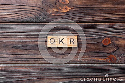 OKR word written on wood block. abbreviation of Objective Key Results text on cement table for your desing, concept Stock Photo