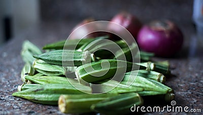 Okra with onions in the background. Stock Photo