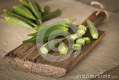 Okra. Vegeteble on a kitchen board, partly chopped Stock Photo