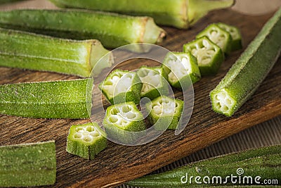 Okra. Vegeteble on a kitchen board, partly chopped Stock Photo