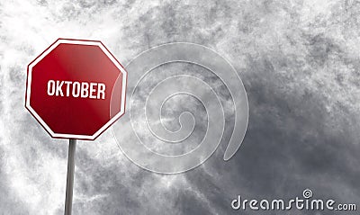 Oktober - red sign with clouds in background Stock Photo