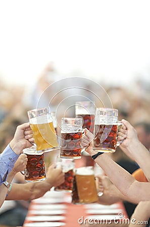 Oktoberfest beer drinkers raise glass Stock Photo