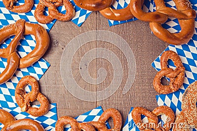 Oktoberfest German beer festival background with wooden board and pretzel. Stock Photo