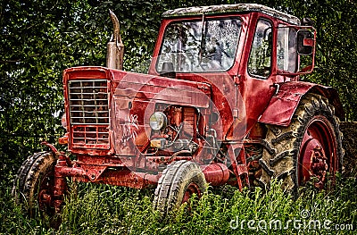 Old abandon red traktor in nature. Stock Photo