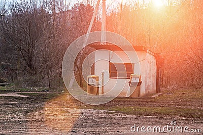 An old abandoned analog fuel station. Industrial zone or production area conquered by nature Stock Photo