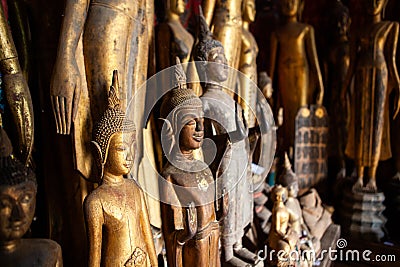 Old abandoned Buddha statues covered with dust at Wat Xieng Thong temple. Luang Prabang, Laos Editorial Stock Photo