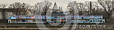 Old abandoned building on the banks of the river, painted with colorful graffiti Cartoon Illustration