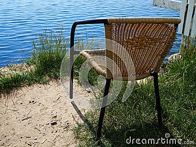 An old abandoned chair in front of the sea Stock Photo