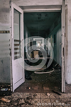 An old abandoned corridor in a pioneer camp. Light from doorways. Shabby walls. Stock Photo