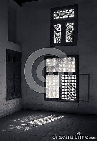 Old abandoned dark damaged dirty room with two wooden broken ornate windows Stock Photo