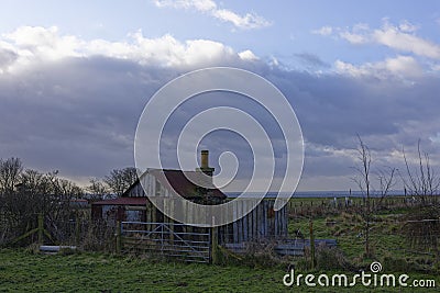 An old abandoned and derelict Railway Hut lies beside the East Coast Railway Line at Easthaven Stock Photo