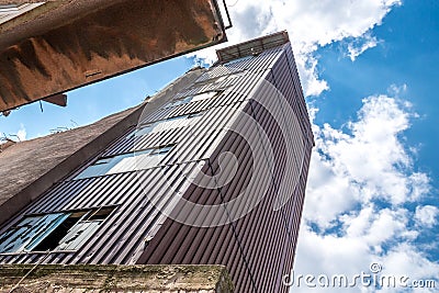 Old abandoned dirty comunism factory building during demolition Stock Photo