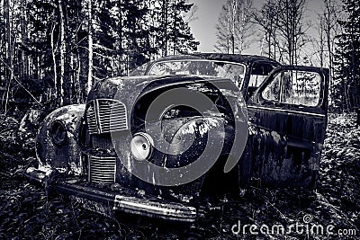 Old abandoned English car standing in a forest in Sweden Editorial Stock Photo